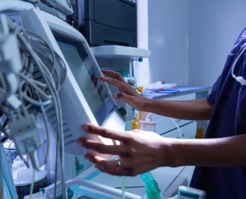 Close up view of healthcare employee using medical equipment