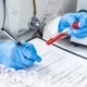 Blood test tubes. Senior female scientist examining blood test tubes at her laboratory dna testing