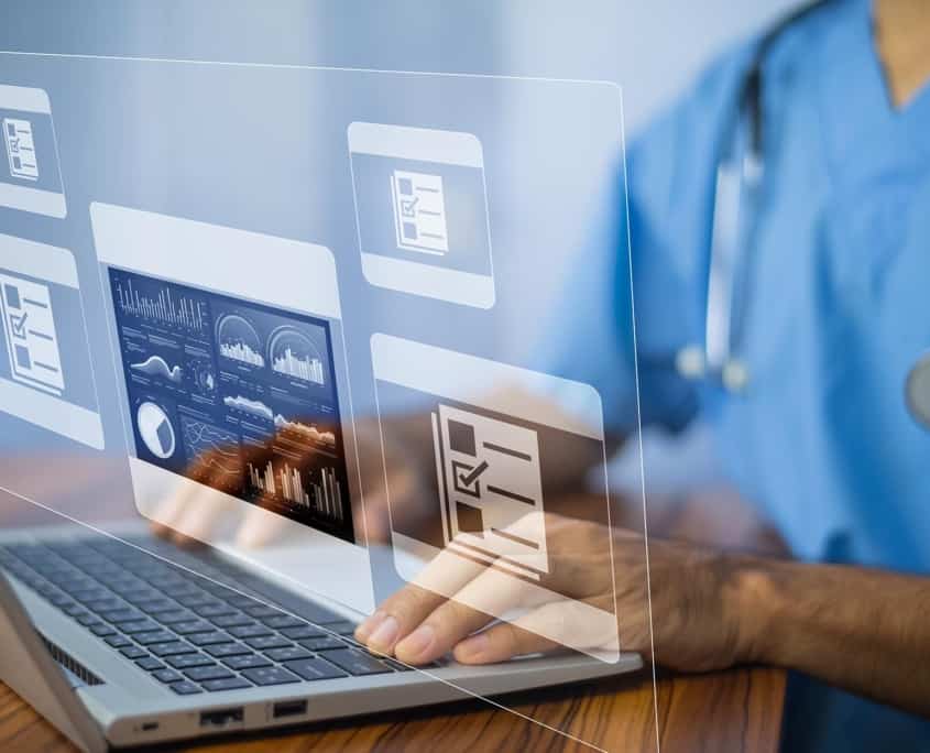 Side view of a physician working on a laptop